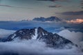 Peaks of Karavanke range and Kamnik-Savinja Alps rise above clouds Royalty Free Stock Photo