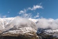 Peaks of snow-capped mountains surrounded by clouds Royalty Free Stock Photo