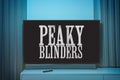 Peaky blinders TV series on big tv screen. Peaky blinders television show at home Royalty Free Stock Photo