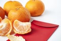 Pealed Mandarin orange on top of Chinese New Year packet