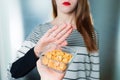 Peanut allergy concept - food intolerance. Young girl refuses to eat peanuts