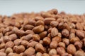 Peanut background, lots of raw peeled brown peanuts close-up. Royalty Free Stock Photo