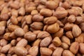 Peanut background, lots of raw peeled brown peanuts close-up. Royalty Free Stock Photo