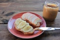 Peanut butter banana and apple sandwiches on wooden background. Slice of bread with peanut paste and fresh fruits on cutting board Royalty Free Stock Photo