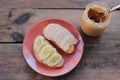 Peanut butter banana and apple sandwiches on wooden background. Slice of bread with peanut paste and fresh fruits on cutting board Royalty Free Stock Photo