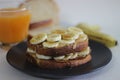 Peanut butter banana honey toast sandwich served with Orange juice, an easy breakfast idea Royalty Free Stock Photo