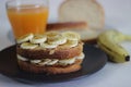 Peanut butter banana honey toast sandwich served with Orange juice, an easy breakfast idea Royalty Free Stock Photo
