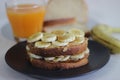 Peanut butter banana honey toast sandwich served with Orange juice, an easy breakfast idea Royalty Free Stock Photo