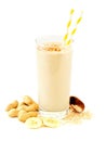 Peanut-butter banana oat smoothie with scattered ingredients over white Royalty Free Stock Photo