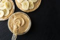 Peanut butter and banana on rice cakes, healthy, dietary food. Black background Royalty Free Stock Photo