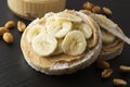 Peanut butter and banana on rice cakes, healthy, dietary food. Black background Royalty Free Stock Photo