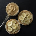 Peanut butter and banana on rice cakes, healthy, dietary food. Black background Royalty Free Stock Photo