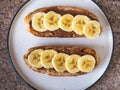 Peanut butter and banana sandwiches, healthy snack on a round plate, close-up Royalty Free Stock Photo
