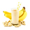 Peanut-butter banana smoothie with scattered ingredients over white Royalty Free Stock Photo