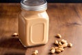 Peanut butter in a glass jar with peanuts on a wooden background. healthy food concept. Generative AI Royalty Free Stock Photo
