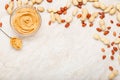 Peanut butter in glass plate with peanuts in shell, peeled peanuts, spoon with peanut butter. Creamy peanut paste flat lay with Royalty Free Stock Photo