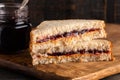 Peanut Butter and Grape Jelly Sandwich on a Wooden Cutting Board Royalty Free Stock Photo