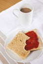 Peanut butter and jam on slices of bread with cup of coffee Royalty Free Stock Photo