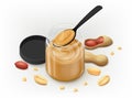 Peanut butter in a glass jar with spoon and lying down groundnut kernels and crumbs