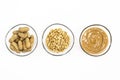 Peanut butter and nuts in three bowls isolated on white.