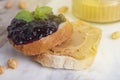 Peanut butter and raspberry jelly sandwich on white background. Sweet breakfast or snack. Close up. Royalty Free Stock Photo