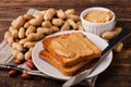 Peanut butter sandwich on plate with inshell peanuts Royalty Free Stock Photo