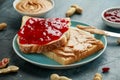 Peanut Butter and strawberry Jelly Sandwich in a blue plate. morning breakfast