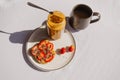 Peanut butter strawberry sandwich and coffee breakfast.