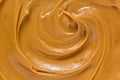 Peanut butter texture background. Creamy smooth brown nut spread swirl