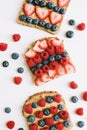 Peanut butter toasts with whole grain brown bread, fresh blueberry, strawberry and raspberry Royalty Free Stock Photo