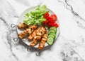 Peanut butter, yogurt and soy sauce chicken satay skewers with fresh vegetables salad on a light background, top view. Delicious Royalty Free Stock Photo