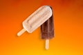 Peanut and chocolate popsicle with orange gradient background Royalty Free Stock Photo