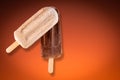 Peanut and chocolate popsicle with orange gradient background Royalty Free Stock Photo