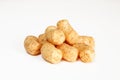 Peanut flips isolated on white background. Pile of snack food close-up