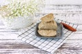 Peanut halva on a plate on white wooden table. Oriental dessert from nuts and seeds with sugar syrup