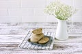 Peanut halva on a plate on white wooden table. Oriental dessert from nuts and seeds with sugar syrup