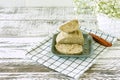 Peanut halva on a plate on white wooden table. Oriental dessert from nuts and seeds with sugar syrup