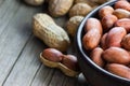 Peanut in nutshell in burlap sack or sackcloth and bowl on wooden background. Composition of peanuts Royalty Free Stock Photo