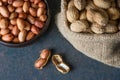 Peanut in nutshell in burlap sack or sackcloth on wooden background. Composition of peanuts Royalty Free Stock Photo