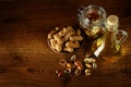 Peanut oil in bottle and dry nuts on wooden table. Top view. Royalty Free Stock Photo