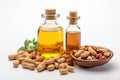 Peanut oil, surrounded by whole peanuts, isolated on a clean white surface