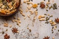 Peanuts Anise Stars Candied Ginger and Pumpkin Seeds in a Brown Dish on White and Gold Cracked Textured Background