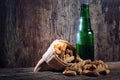 Peanuts and beer on wood background Royalty Free Stock Photo