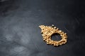 Peanuts on black table. Heap of roasted peeled peanuts in the form of a drop Royalty Free Stock Photo