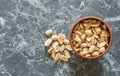 Peanuts in a bowl and next to it Royalty Free Stock Photo
