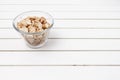 peanuts in a bowl over a white rustic table Royalty Free Stock Photo