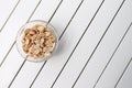 Peanuts in a bowl over a white rustic table Royalty Free Stock Photo