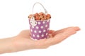 Peanuts in a bucket in hand