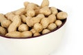 Peanuts in a ceramic bowl on a white background