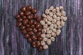 Peanuts in chocolate. Peanut with caramel and sesame seeds. Sweet peanut posted heart. Royalty Free Stock Photo